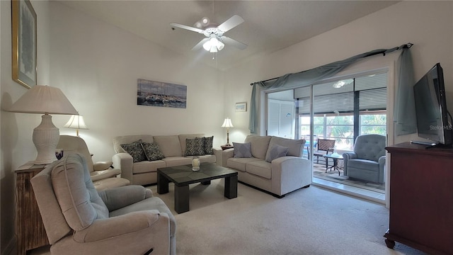 living room with vaulted ceiling, light colored carpet, and ceiling fan