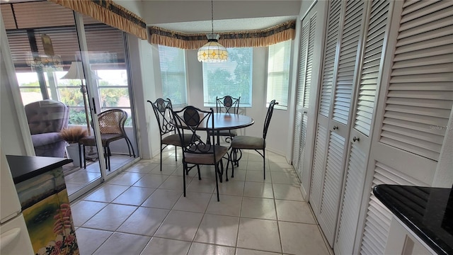 tiled dining space with a chandelier