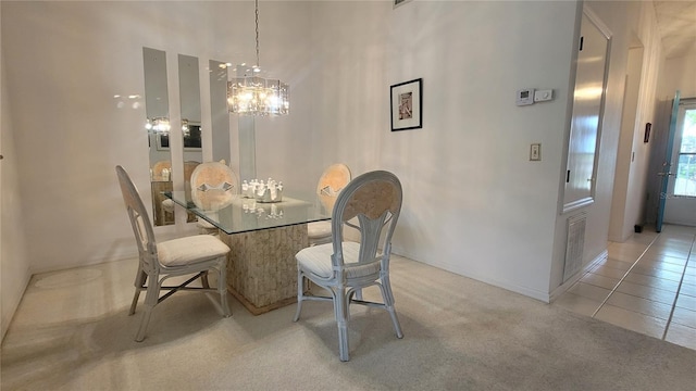 dining area with an inviting chandelier and light carpet