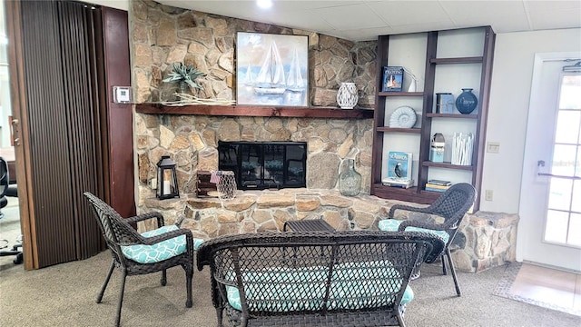 living room with carpet and a fireplace