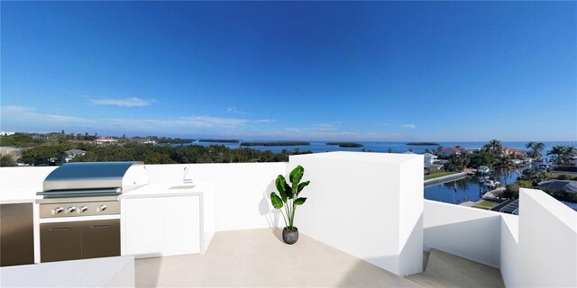 view of patio / terrace with a balcony, exterior kitchen, a water view, and a grill