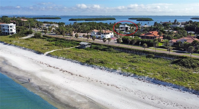 bird's eye view with a water view and a beach view