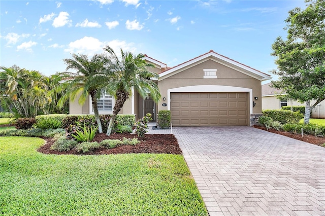 view of front of house featuring a garage and a front lawn