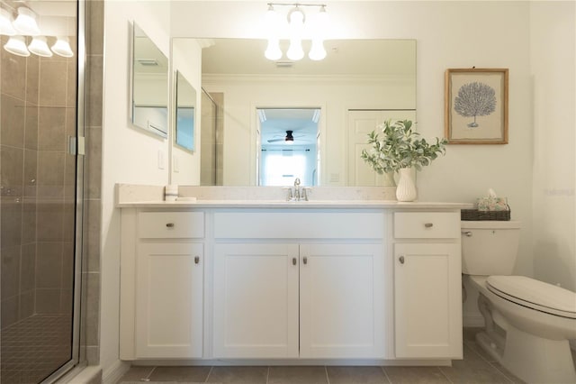 bathroom featuring tile floors, vanity, toilet, and crown molding