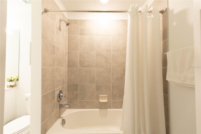 bathroom featuring shower / tub combo with curtain and toilet