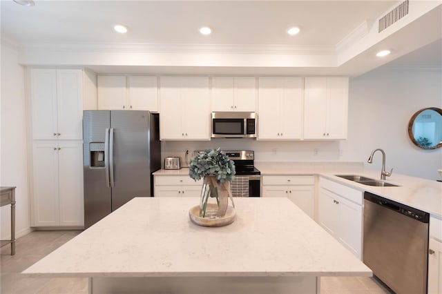 kitchen featuring stainless steel appliances, light stone counters, white cabinetry, sink, and light tile floors