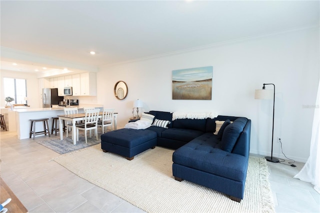 living room featuring ornamental molding and light tile floors