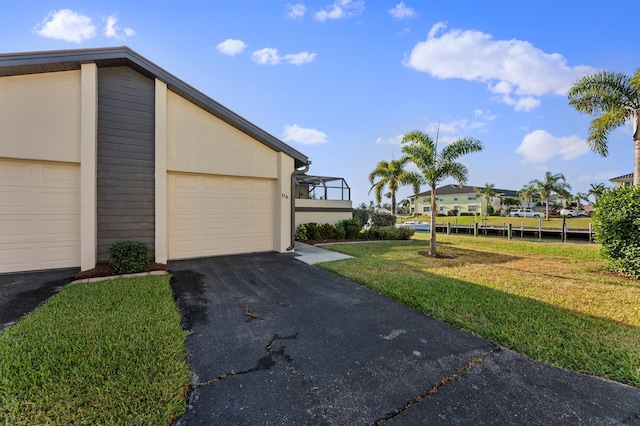 exterior space featuring a front lawn and a garage