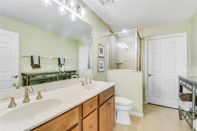 bathroom featuring double vanity, tile floors, and toilet