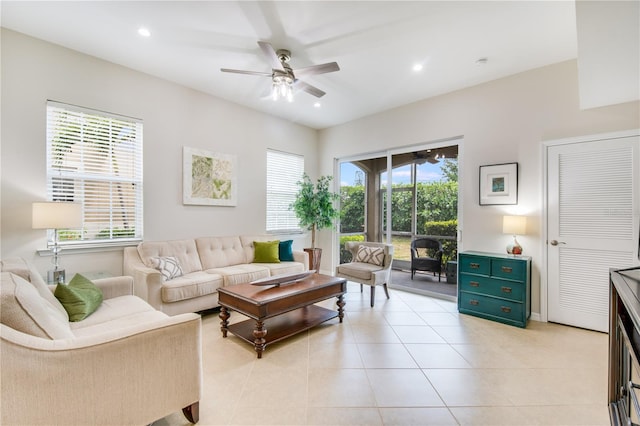 living room featuring plenty of natural light, ceiling fan, and light tile floors