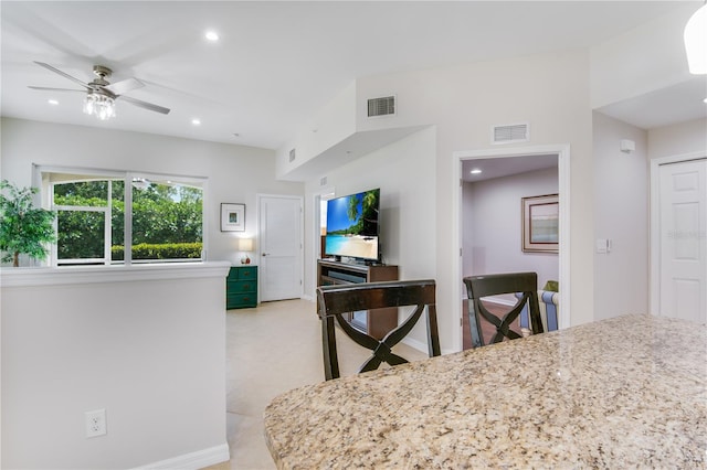 kitchen featuring ceiling fan and light tile floors