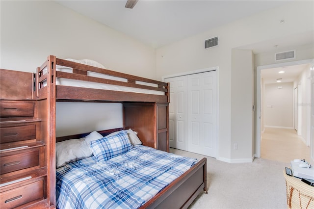 carpeted bedroom with a closet and ceiling fan