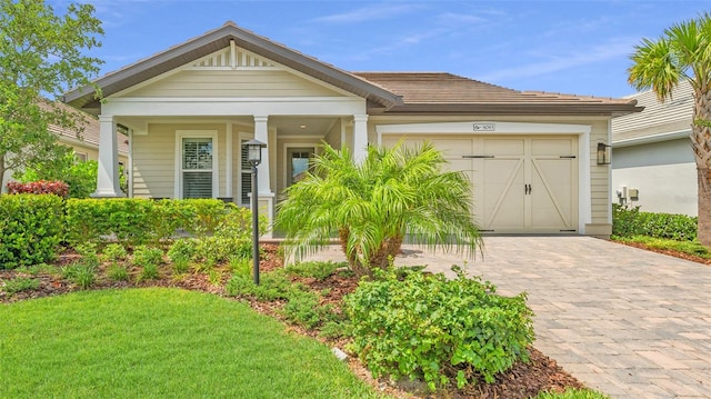 view of front of house featuring a garage and a front lawn