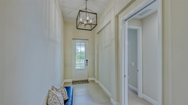 entryway with a chandelier and light tile flooring