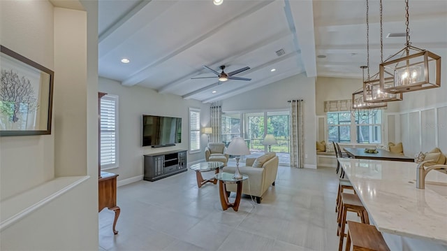 tiled living room with beamed ceiling, sink, ceiling fan with notable chandelier, and high vaulted ceiling