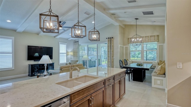 kitchen featuring sink, pendant lighting, light tile floors, and vaulted ceiling with beams