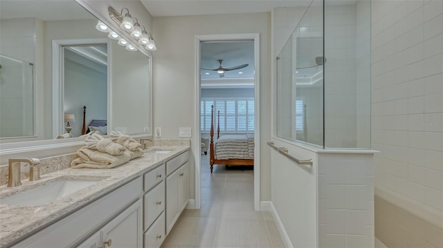 bathroom with a shower with door, large vanity, ceiling fan, tile floors, and dual sinks