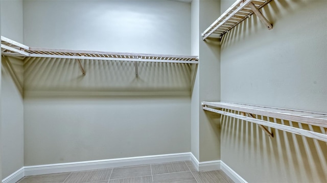 spacious closet featuring tile flooring