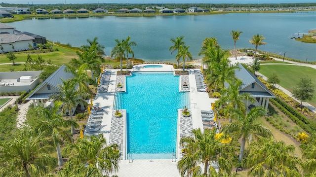 view of swimming pool featuring a water view