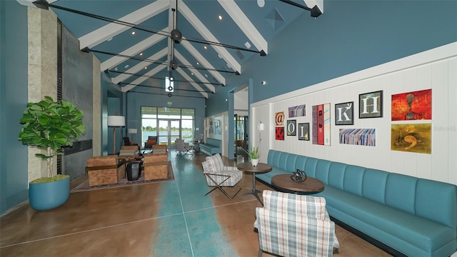 interior space featuring high vaulted ceiling, beam ceiling, and concrete flooring