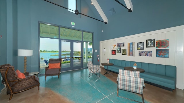 living room featuring high vaulted ceiling, french doors, a water view, beamed ceiling, and concrete floors