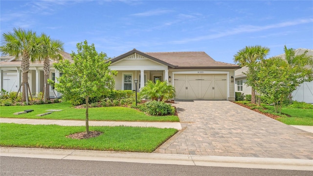 view of front of home with a garage and a front lawn