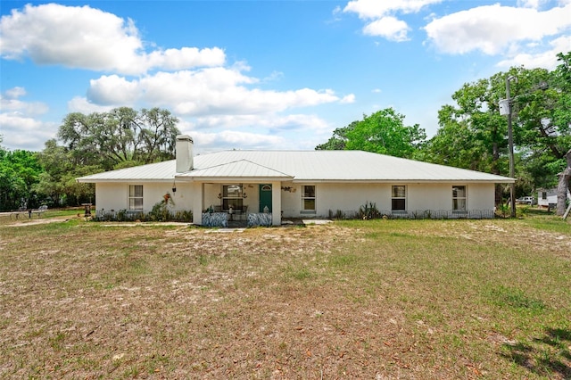 rear view of house with a lawn