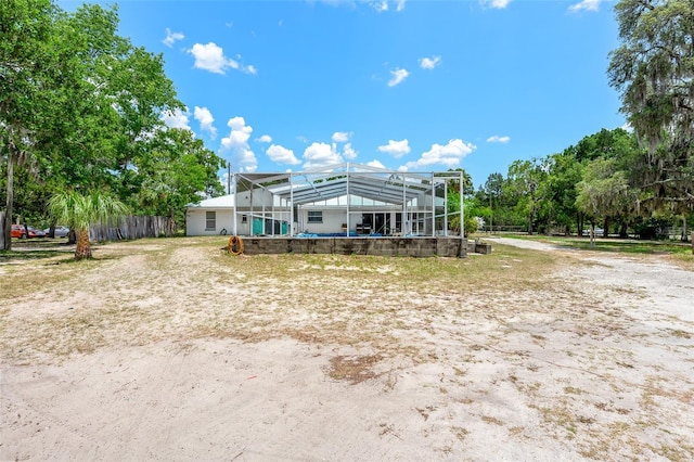 rear view of property with a lanai