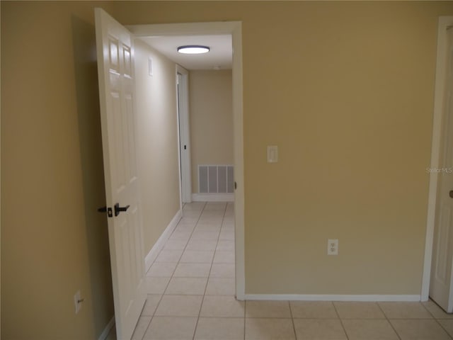 hall with light tile patterned floors