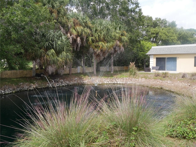 view of swimming pool with a water view