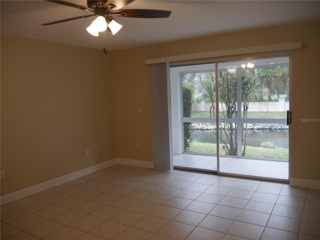 tiled spare room with ceiling fan