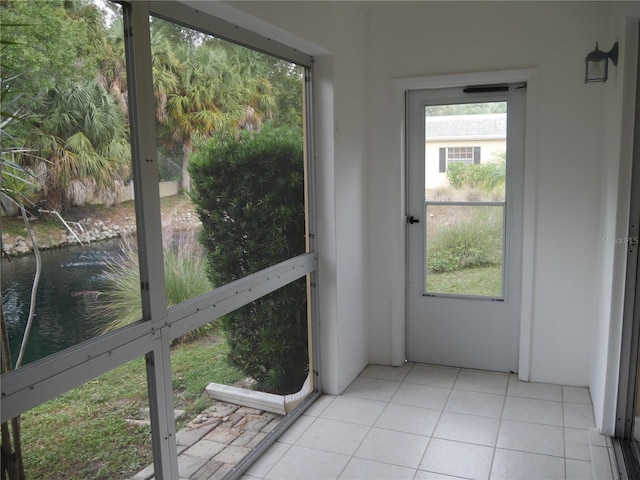 unfurnished sunroom with a water view