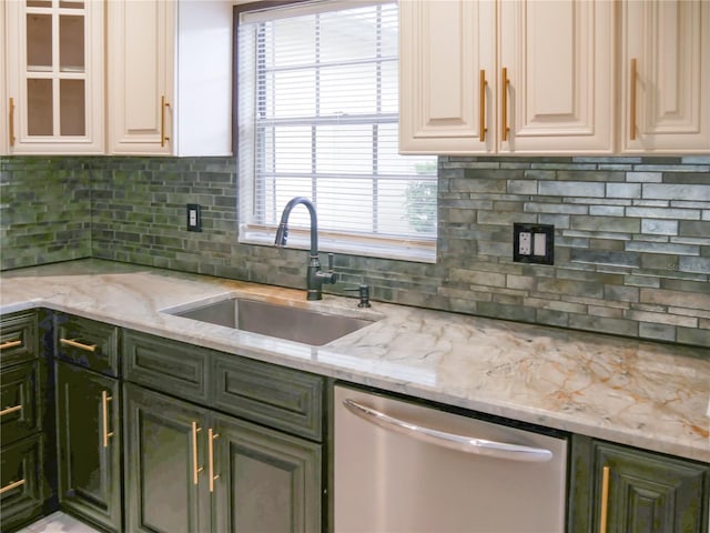 kitchen with light stone counters, sink, stainless steel dishwasher, and plenty of natural light