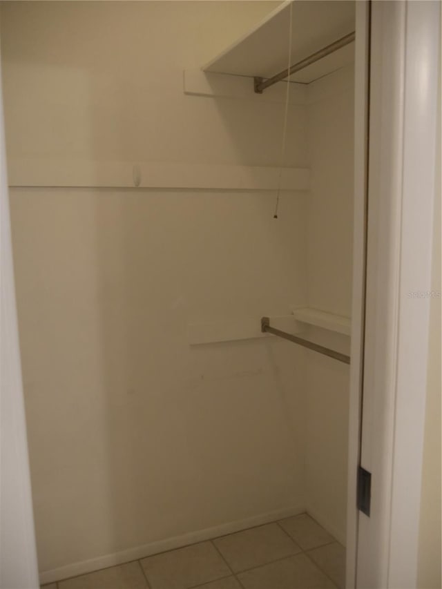 spacious closet featuring light tile patterned floors