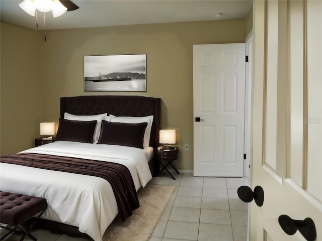 bedroom with ceiling fan and light tile patterned flooring