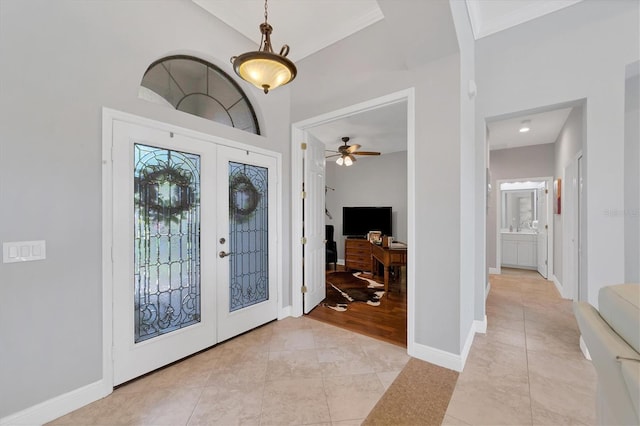 tiled entrance foyer with french doors and ceiling fan