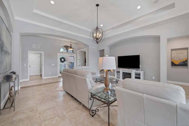 living room with light tile flooring, a raised ceiling, and an inviting chandelier