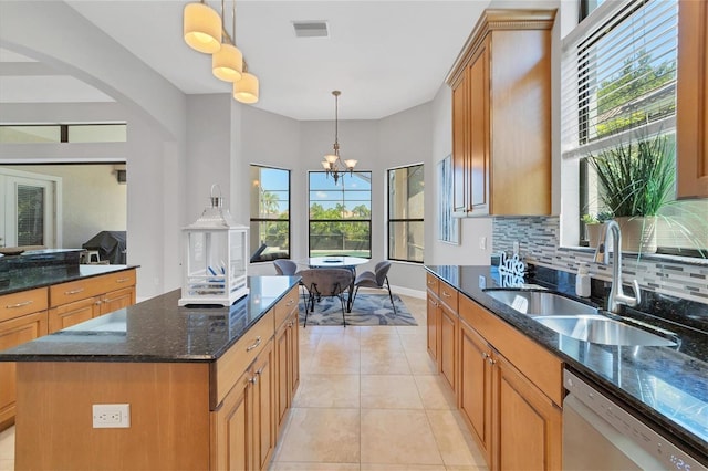 kitchen with backsplash, light tile flooring, dishwasher, sink, and pendant lighting