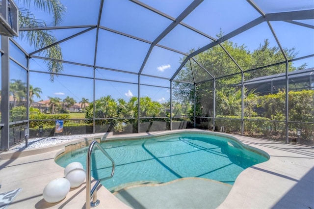 view of pool with a patio area and glass enclosure