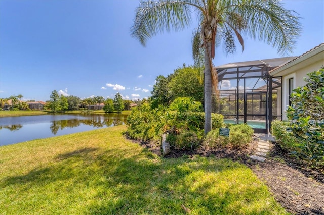 view of yard featuring a water view and glass enclosure