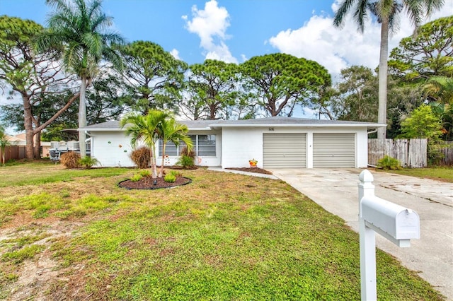 ranch-style home featuring a garage and a front yard