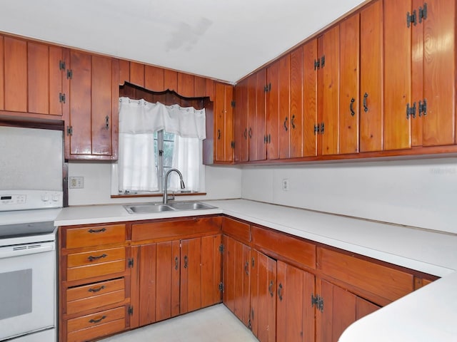 kitchen featuring sink and white range with electric cooktop