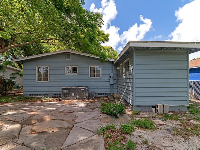 back of house with central air condition unit and a patio area