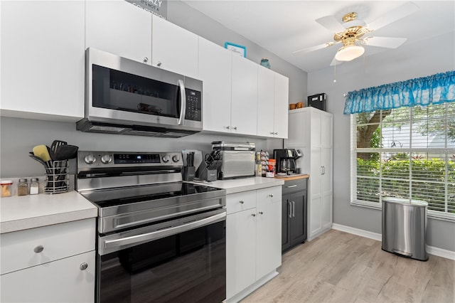 kitchen featuring ceiling fan, light hardwood / wood-style floors, white cabinets, and appliances with stainless steel finishes