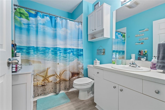 bathroom featuring hardwood / wood-style flooring, toilet, and vanity