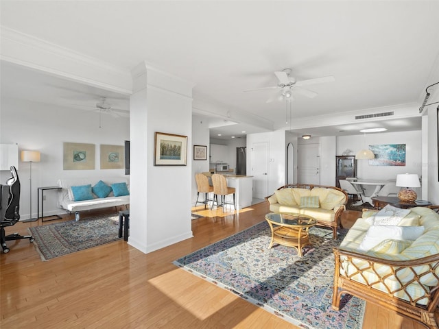 living room with wood-type flooring and ceiling fan