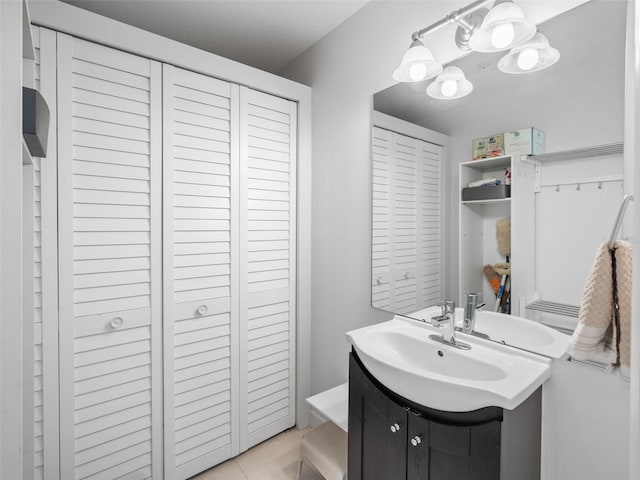 bathroom featuring a chandelier, tile floors, and large vanity