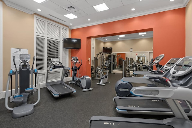 workout area with a drop ceiling and ornamental molding