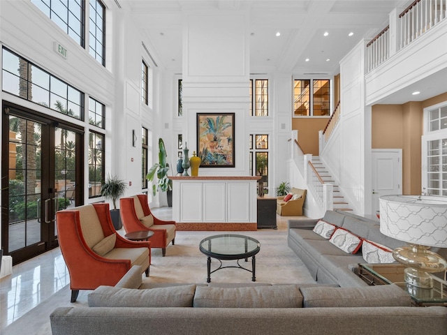 tiled living room featuring a wealth of natural light, coffered ceiling, beam ceiling, and a high ceiling