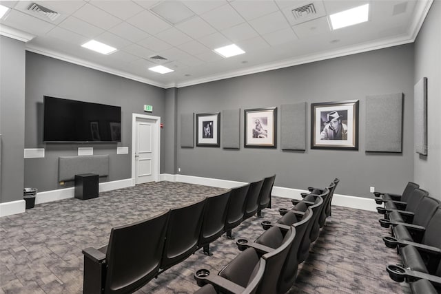 home theater room featuring a drop ceiling, crown molding, and carpet floors